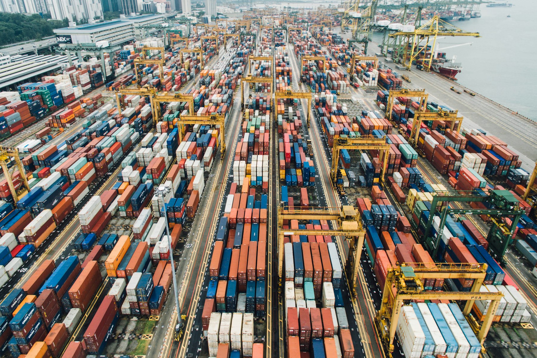 Aerial view of a container terminal with gantry cranes and a ship at the quay